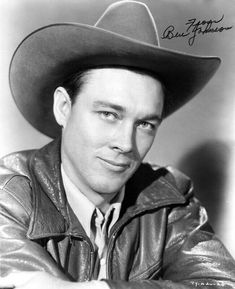 a black and white photo of a man wearing a cowboy hat