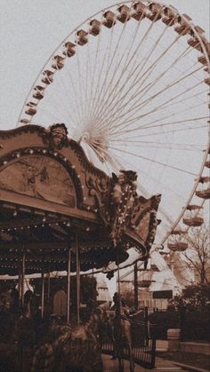 an old photo of a carnival ride with a ferris wheel in the backgrouund