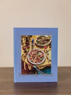 a cookbook sitting on top of a wooden table