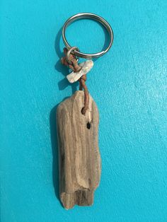 a wooden keychain with a piece of wood hanging from it's side