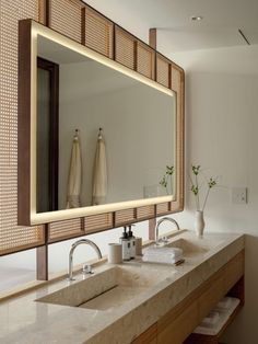 a bathroom with two sinks and a large mirror over it's counter top,