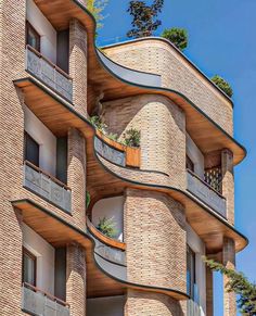 an apartment building with many balconies and plants on the balconies are shown