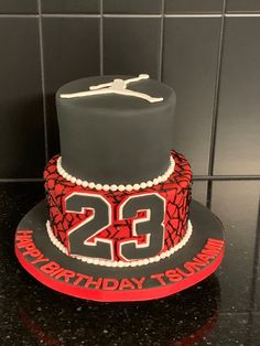 a birthday cake with the number twenty two on it and a basketball jersey as decoration