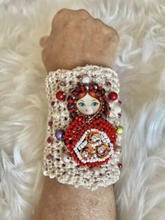 a woman's arm with a bracelet made out of beads and beads on it