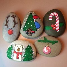 four painted rocks with christmas designs on them