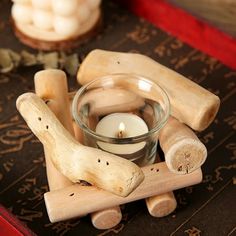 a candle and some wood pieces on a table