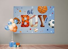 a sports themed birthday banner with balloons and gifts on the floor in front of it