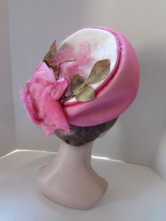 "SALE! 10% OFF! Striking Mid Century Hat in Peony Pink Chiffon. We will call this a modified bubble style, as it soars at front, but flattens at the back. Marche Exclusive designed this in a union shop. The peony pink chiffon covers white millinery straw. At the back of the crown poses the 6\" pink rose. Net covers all. See condition report below. In mid century style, this would be worn toward the top of the head, not at the forehead Size: 4 1/2\" tall at front to 1/2\" at the back; 6 1/4\" acr Vintage Pink Fitted Fascinator, Retro Pink Wide Brim Hat, Vintage Pink Hat For Evening, Vintage Pink Evening Hat, Fitted Vintage Pink Hat, Vintage Fitted Pink Hat, Vintage Pink Cloche Hat, Retro Pink Brimmed Hat, Vintage Pink Wide Brim Hat