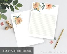 two sheets of white paper with flowers on them next to a pen and some rubber stamps