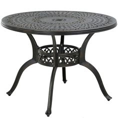 an iron table with circular design on the top and bottom, sitting against a white background