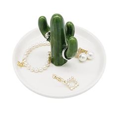 a white plate topped with a cactus and pearls