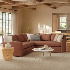 a living room with a sectional couch and coffee table