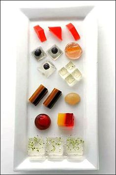 a white plate topped with lots of different types of sushi and other food items