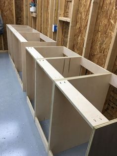 some unfinished cabinets are in the process of being assembled and put into place for storage