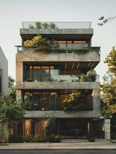 an apartment building with plants growing on the balconies