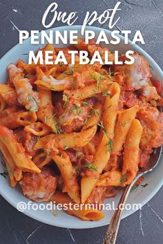 one pot penne pasta meatballs in a white bowl with a spoon on the side