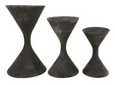 three black vases sitting next to each other on a white background, one is tall and the other two are short