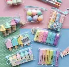 several different types of erasers in plastic bags on a blue and pink tablecloth