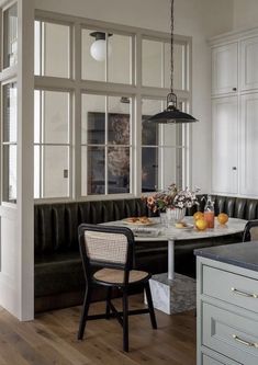 a black and white dining room with wood flooring