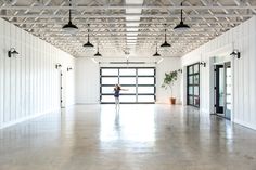 an empty room with white walls and ceiling lights