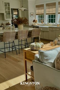 a living room filled with furniture and lots of counter space next to a kitchen island