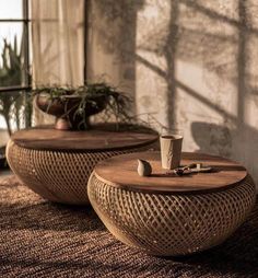 two wooden tables sitting next to each other on top of a carpeted floor in front of a window