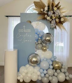 a table topped with balloons and a cross