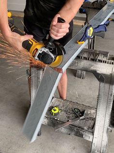 a man using a power tool on a piece of metal