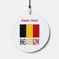 a round ornament with the name here and belgium in red, black, yellow, and green