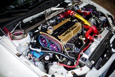 the engine compartment of a white car with its hood open