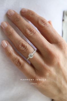 a woman's hand with a diamond ring on it