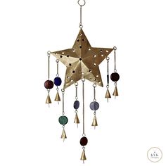 a metal star with bells hanging from it's sides and stars on the side