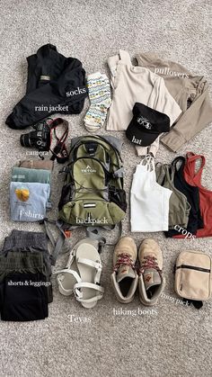 the contents of a backpack are laid out on the floor, including shoes and other items