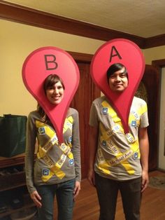 two people standing in front of each other with heart shaped signs on their heads that spell out the letters ba