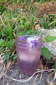 a purple drink is sitting on the ground