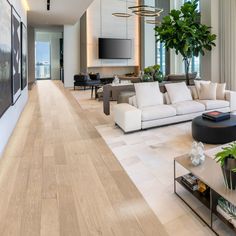 a living room filled with furniture and a flat screen tv mounted to the side of a wall