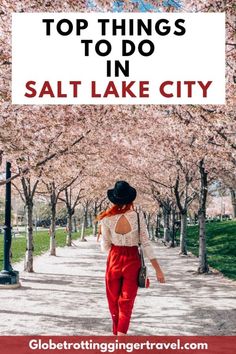 a woman walking down a path with cherry trees in the background and text overlaying top things to do in salt lake city