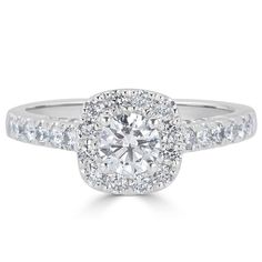 a white gold engagement ring with round diamonds on the band and an oval center stone