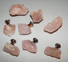 several pieces of pink crystal on a white surface