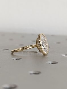 a diamond ring sitting on top of a table with lots of small dots around it