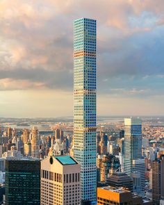 an aerial view of the skyscrapers in new york city, with clouds above them