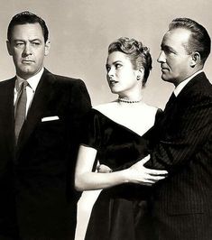 an old black and white photo of two men and a woman standing next to each other