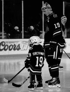 an old photo of two young hockey players