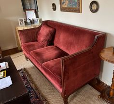 a red couch sitting in the corner of a living room