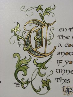 the letter d is decorated with green and gold leaves, vines, and swirls