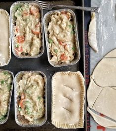 six pans filled with different types of food on top of a baking sheet next to dough