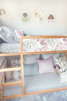 a child's room with bunk beds and pictures on the wall above them,