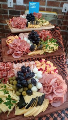 three trays filled with different types of food on top of a table next to each other