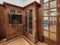 an empty room with wooden furniture and glass doors