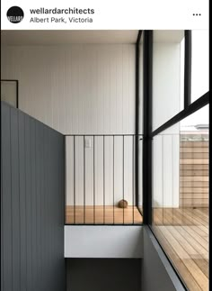 an open balcony with wooden floors and white walls